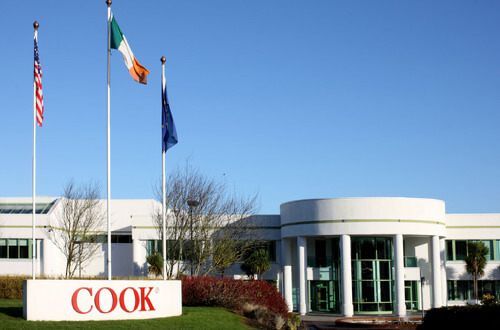 Cook Medical Ireland building and sign with country flags