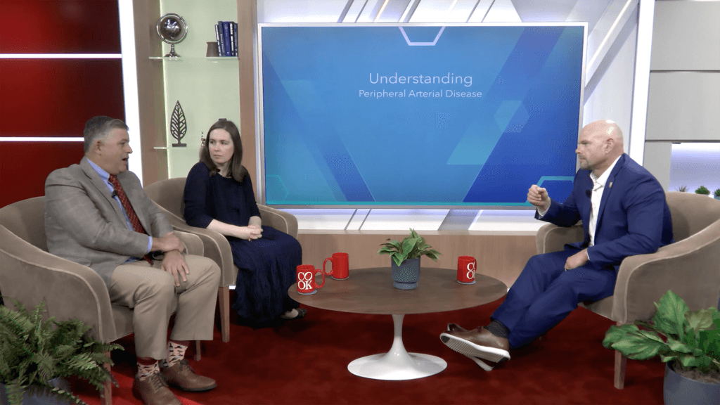 Dr. Peña and Dr. McMackin sitting in a conference room with host Jeremy Andrews discussing choosing PAD access sites and strategies.